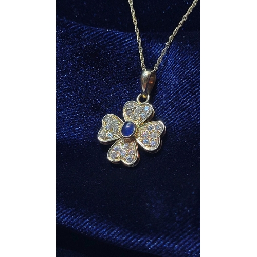 119 - A REALLY PRETTY SPARKLING 14 CT GOLD DIAMOND & BLUE SAPPHIRE PENDANT, on a 14ct gold delicate chain.... 