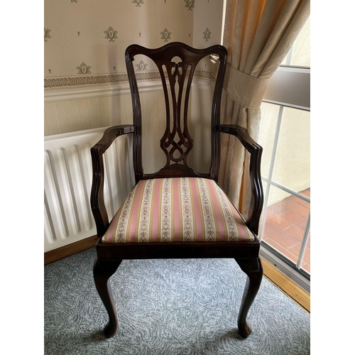 125 - AN EDWARDIAN MAHOGANY FRAMED ARMCHAIR, with carved openwork back splat within fluted frame, upholste... 