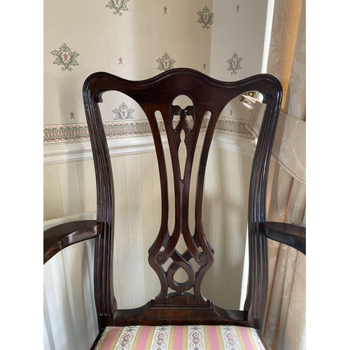 125 - AN EDWARDIAN MAHOGANY FRAMED ARMCHAIR, with carved openwork back splat within fluted frame, upholste... 