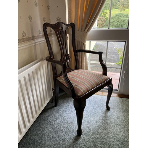 125 - AN EDWARDIAN MAHOGANY FRAMED ARMCHAIR, with carved openwork back splat within fluted frame, upholste... 