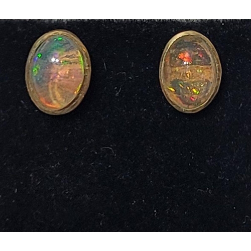 126 - A VINTAGE PAIR OF OVAL SHAPED BEZEL SET OPAL EARRINGS / STUDS, beautiful dynamic movement in the col... 