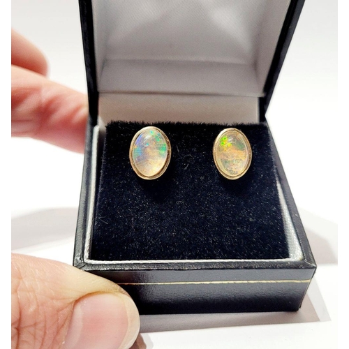 126 - A VINTAGE PAIR OF OVAL SHAPED BEZEL SET OPAL EARRINGS / STUDS, beautiful dynamic movement in the col... 