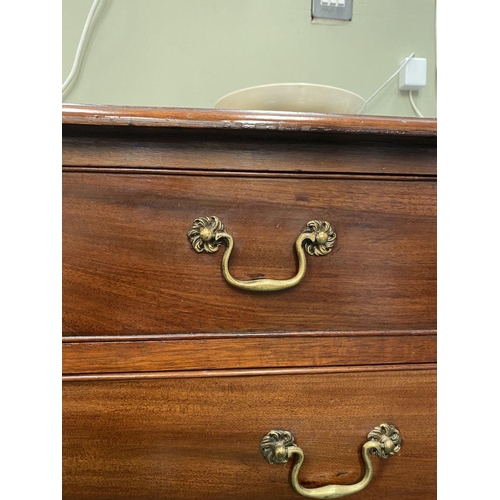 137 - AN ATTRACTIVE NEAT SIZED GEORGIAN MAHOGANY CHEST OF DRAWERS, with molded edge to rectangular top abo... 