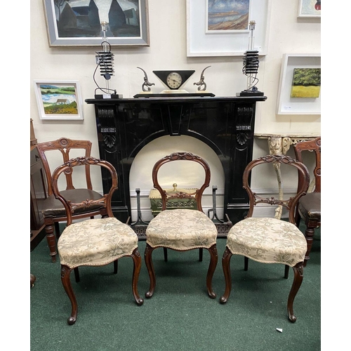 140 - A SET OF THREE EARLY VICTORIAN MAHOGANY DINING CHAIRS, the balloon back with foliate carvings above ... 