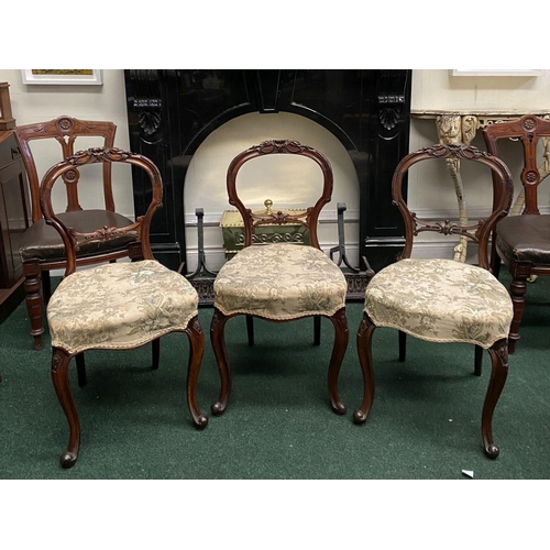 140 - A SET OF THREE EARLY VICTORIAN MAHOGANY DINING CHAIRS, the balloon back with foliate carvings above ... 