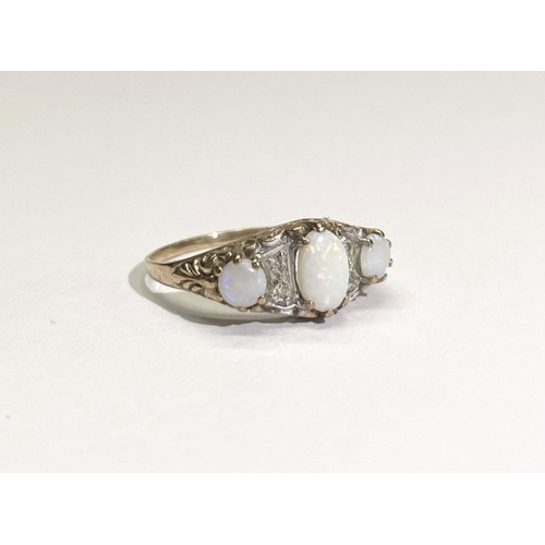 172 - A PRETTY GOLD THREE STONE OPAL AND DIAMOND RING, with large oval opal to centre flanked by round cut... 