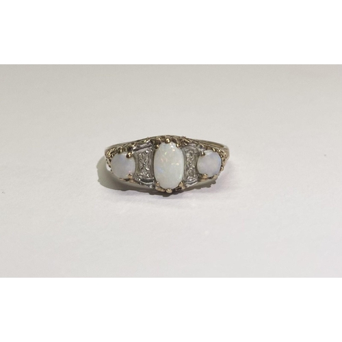 172 - A PRETTY GOLD THREE STONE OPAL AND DIAMOND RING, with large oval opal to centre flanked by round cut... 