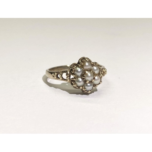 175 - A VERY NICE 9CT GOLD FLORAL PEARL CLUSTER RING, with central seeded pearl in claw setting surrounded... 