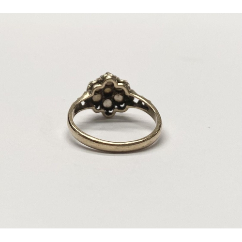 175 - A VERY NICE 9CT GOLD FLORAL PEARL CLUSTER RING, with central seeded pearl in claw setting surrounded... 