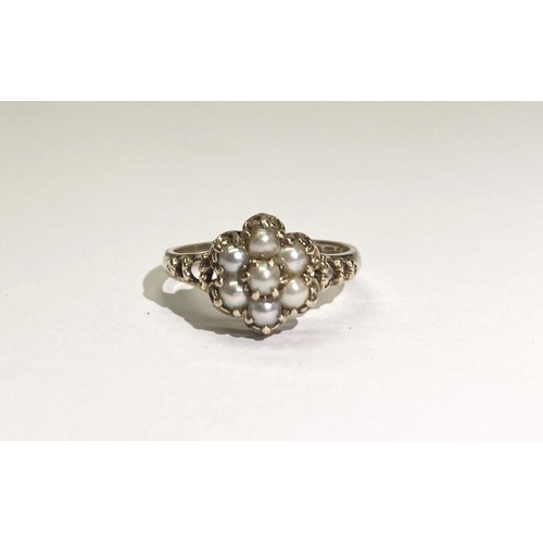 175 - A VERY NICE 9CT GOLD FLORAL PEARL CLUSTER RING, with central seeded pearl in claw setting surrounded... 