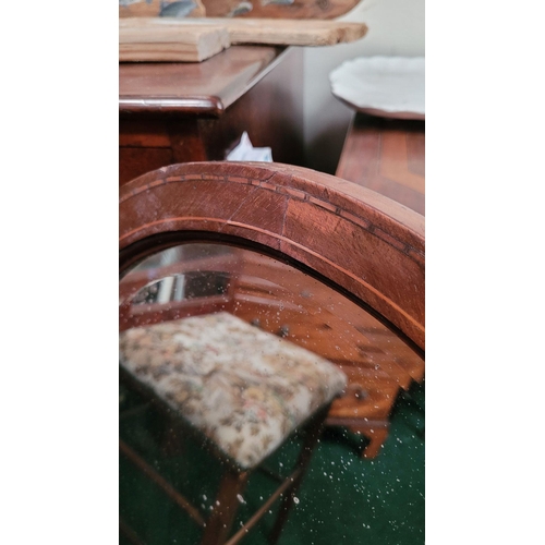 187 - A MAHOGANY INALID OVAL SHAPED BEVELLED WALL MIRROR, very heavy with a panelled wooden back. Frame ha... 