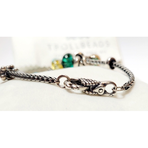 192 - A FANTASTIC TROLLBEADS STERLING SILVER BRACELET WITH CHARMS, presented in original box on a soft rib... 