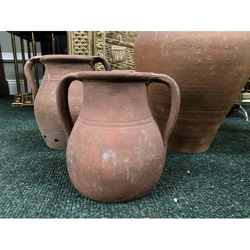 209 - A COLLECTION OF THREE TERRACOTTA PLANTERS, two of urn form with double handles, the larger of urn fo... 