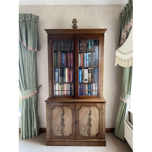 21 - AN EXCELLENT FLAME MAHOGANY LIBRARY BOOKCASE, with cornice above two large glazed doors with three s... 