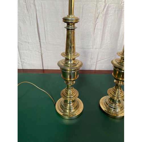 22 - A PAIR OF VERY GOOD QUALITY POLISHED BRASS RING TURNED BRASS TABLE LAMPS, both measuring 59cm tall, ... 