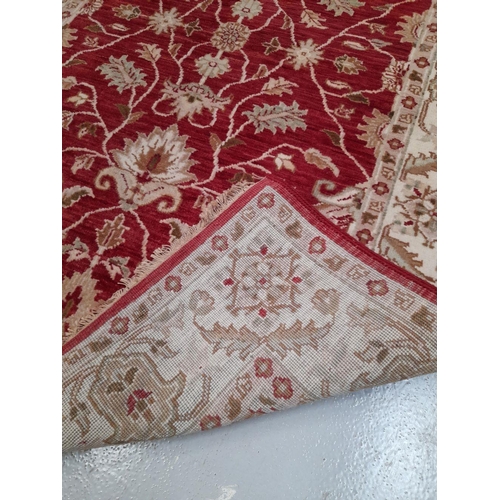 26 - AN EXCELLENT CHOBI CARPET, hand woven, featuring a traditional floral pattern in vibrant deep red an... 