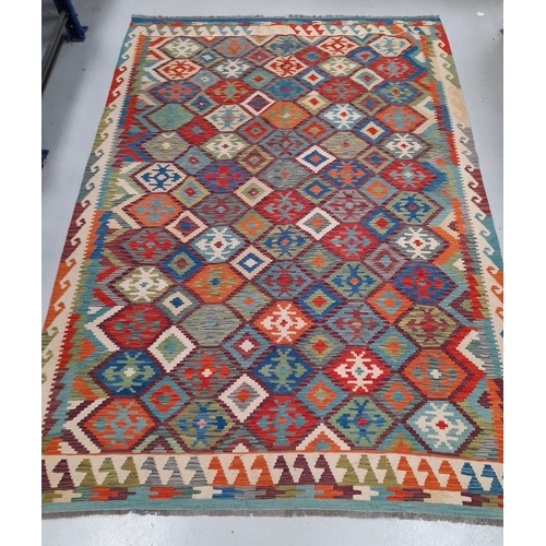 41 - A TRADITIONAL KELLIM RUG, hand woven, featuring diamond pattern with geometric motifs, in vibrant re... 