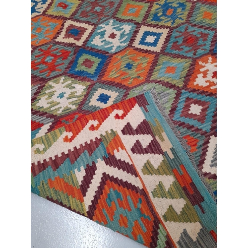 41 - A TRADITIONAL KELLIM RUG, hand woven, featuring diamond pattern with geometric motifs, in vibrant re... 