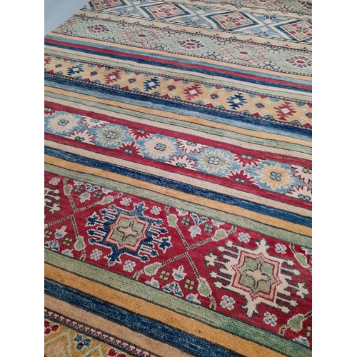 43 - AN EXCELLENT AFGHAN KAZAK RUG, hand woven, with multiple striped geometric panels in vibrant blue, r... 