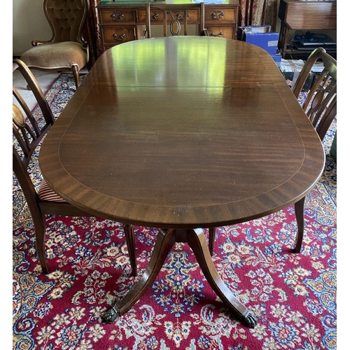 44 - A GOOD MAHOGANY CROSSBANDED EXTENDING DINING TABLE, the oval top with crossbanded border atop turned... 