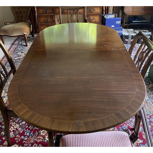 44 - A GOOD MAHOGANY CROSSBANDED EXTENDING DINING TABLE, the oval top with crossbanded border atop turned... 