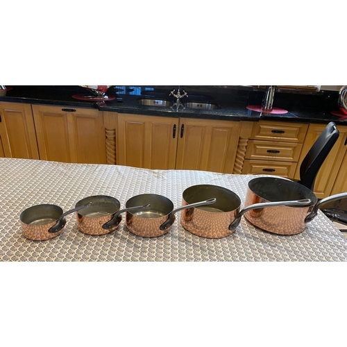 45 - A VERY GOOD SET OF FIVE POLISHED FRENCH COPPER & CAST IRON HANDLED GRADUATED SAUCEPANS, impressed to... 