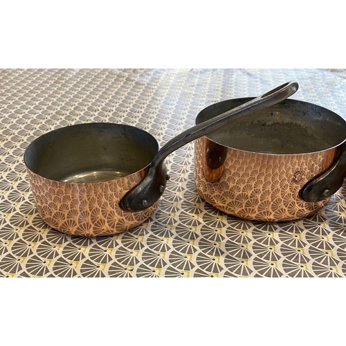 45 - A VERY GOOD SET OF FIVE POLISHED FRENCH COPPER & CAST IRON HANDLED GRADUATED SAUCEPANS, impressed to... 