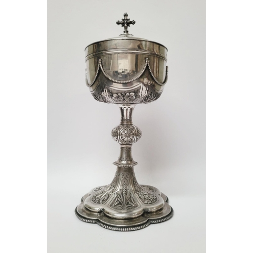 47 - A VERY DECORATIVE IRISH SILVER & GILT CIBORIUM, the lid with a cross finial, the bowl decorated with... 