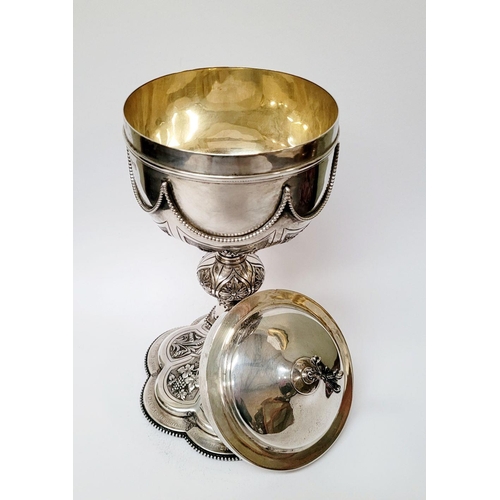 47 - A VERY DECORATIVE IRISH SILVER & GILT CIBORIUM, the lid with a cross finial, the bowl decorated with... 