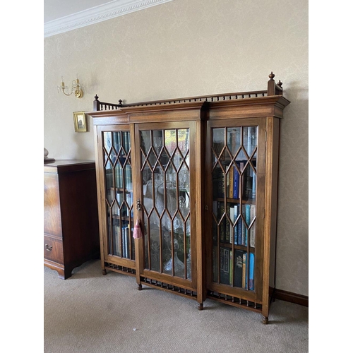 49 - A FINE ASTRAL GLAZED BREAKFRONT THREE DOOR DISPLAY CABINET, with three quarter gallery to top above ... 