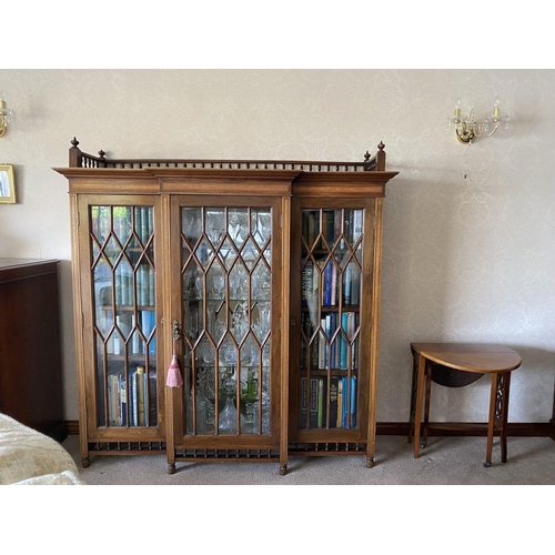 49 - A FINE ASTRAL GLAZED BREAKFRONT THREE DOOR DISPLAY CABINET, with three quarter gallery to top above ... 