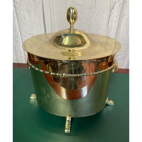 51 - A GOOD QUALITY POLISHED BRASS OVAL SHAPED LIFT TOP FIRE FUEL BOX, with a rope decoration band and cu... 