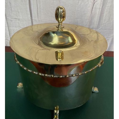 51 - A GOOD QUALITY POLISHED BRASS OVAL SHAPED LIFT TOP FIRE FUEL BOX, with a rope decoration band and cu... 