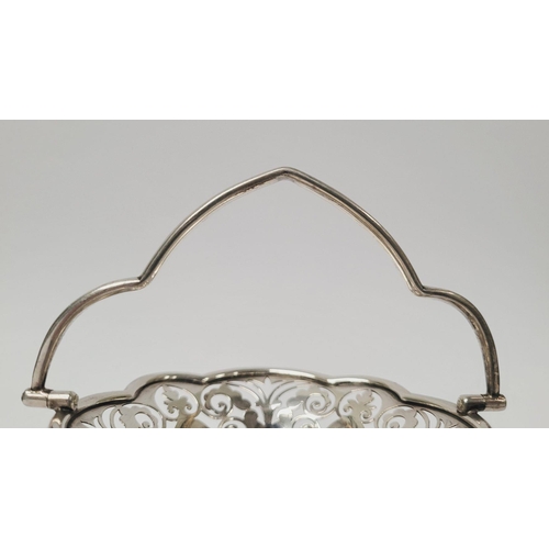 6 - A BEAUTIFUL EARLY 19TH CENTURY SOLID SILVER SCALLOP EDGED BASKET WITH SWING HANDLE, decorated with a... 