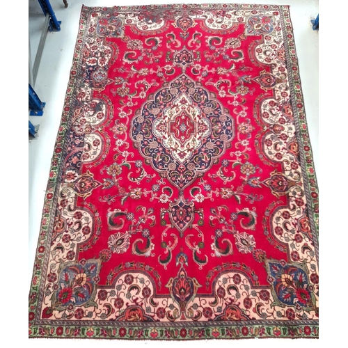 60 - A VIBRANT PERSIAN TABRIZ RUG, hand-knotted, featuring traditional Tabriz design with central medalli... 