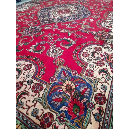 60 - A VIBRANT PERSIAN TABRIZ RUG, hand-knotted, featuring traditional Tabriz design with central medalli... 