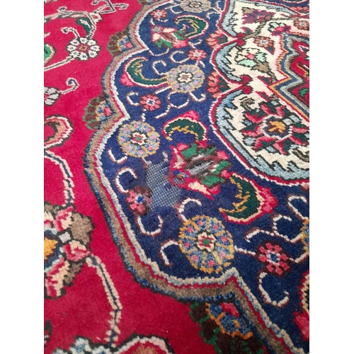 60 - A VIBRANT PERSIAN TABRIZ RUG, hand-knotted, featuring traditional Tabriz design with central medalli... 