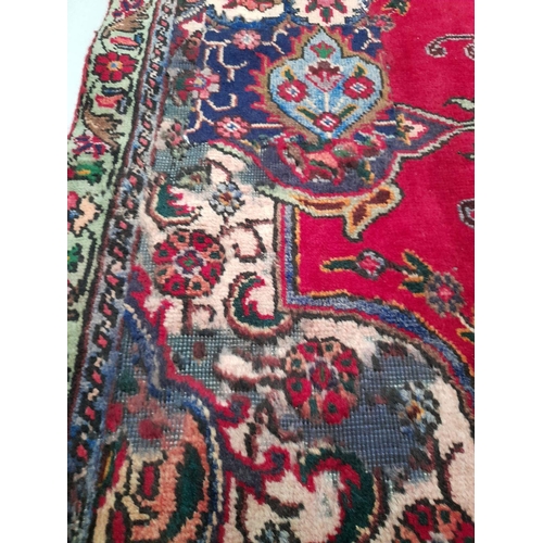 60 - A VIBRANT PERSIAN TABRIZ RUG, hand-knotted, featuring traditional Tabriz design with central medalli... 