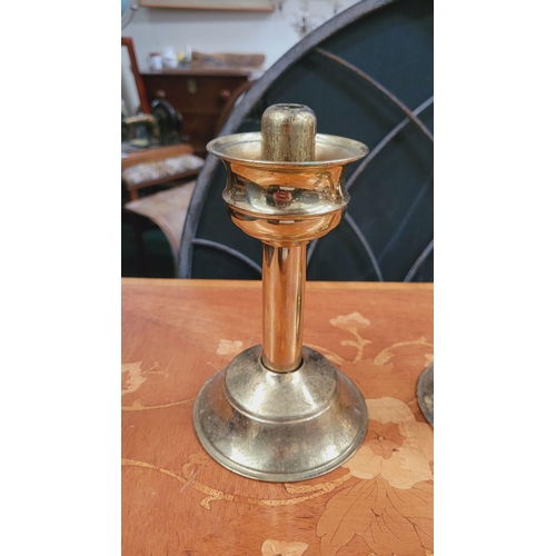 77 - A PAIR OF VINTAGE BRASS SPRING LOADED CANDLESTICKS, 18cm tall each. The brass top twists and lifts o... 