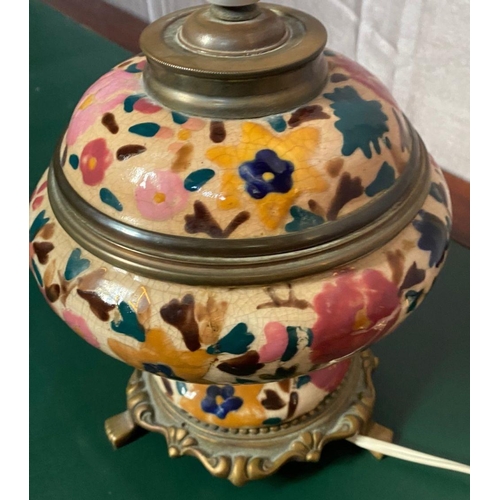 84 - A VINTAGE CRACKLE GLAZE BRASS MOUNTED TABLE LAMP, decorated with floral design. 30cm tall.