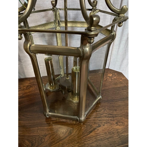 93 - A VERY GOOD QUALITY PAIR OF BRASS GLAZED HANGING LANTERN LIGHTS, each with scrolling open work to th... 