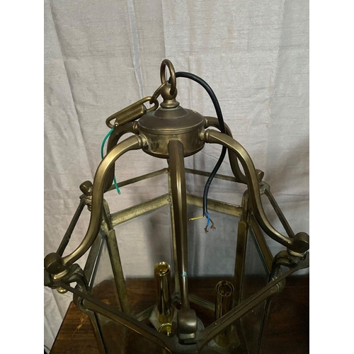 93 - A VERY GOOD QUALITY PAIR OF BRASS GLAZED HANGING LANTERN LIGHTS, each with scrolling open work to th... 