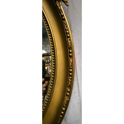 99 - A VERY GOOD QUALITY PAIR OF OVAL SHAPED GILT WALL MIRRORS – DECORATED WITH BEAUTIFUL SCROLLING RIBBO... 