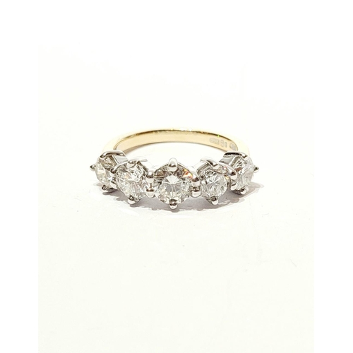 11 - A SPECTACULAR 18CT GOLD FIVE STONE GRADUATED DIAMOND RING, with a central diamond of .6cts, flanked ... 