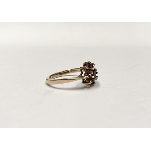 112 - A PRETTY VINTAGE 9CT GOLD GARNET CLUSTER RING, with central round cut garnet in eight claw setting, ... 