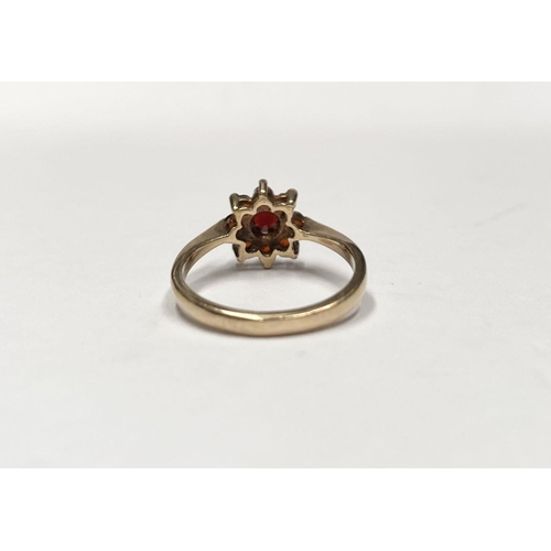 112 - A PRETTY VINTAGE 9CT GOLD GARNET CLUSTER RING, with central round cut garnet in eight claw setting, ... 