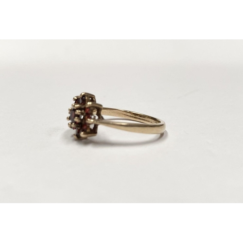 112 - A PRETTY VINTAGE 9CT GOLD GARNET CLUSTER RING, with central round cut garnet in eight claw setting, ... 