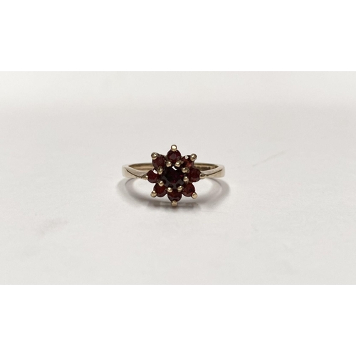 112 - A PRETTY VINTAGE 9CT GOLD GARNET CLUSTER RING, with central round cut garnet in eight claw setting, ... 