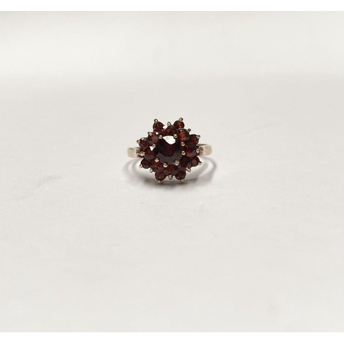 114 - A VINTAGE 9CT GOLD GARNET CLUSTER RING, with central round cut garnet in eight claw setting surround... 