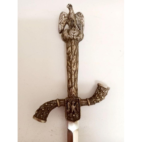 129 - A DECORATIVE LETTER OPENER/PAPER KNIFE, the handle topped with an eagle, 26cm long.